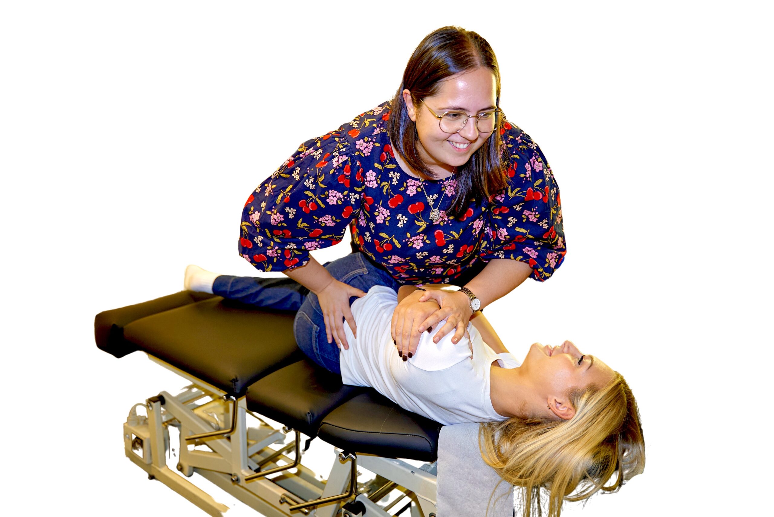 Dr Aisling Finneran adjusting a happy patient on a chiropractic table